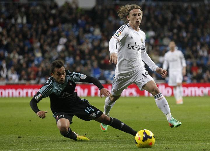 Real Madrid's Luka Modric battles for the ball with Celta Vigo's Fabian Orellana during their Spanish First Division soccer match at Santiago Bernabeu stadium in Madrid